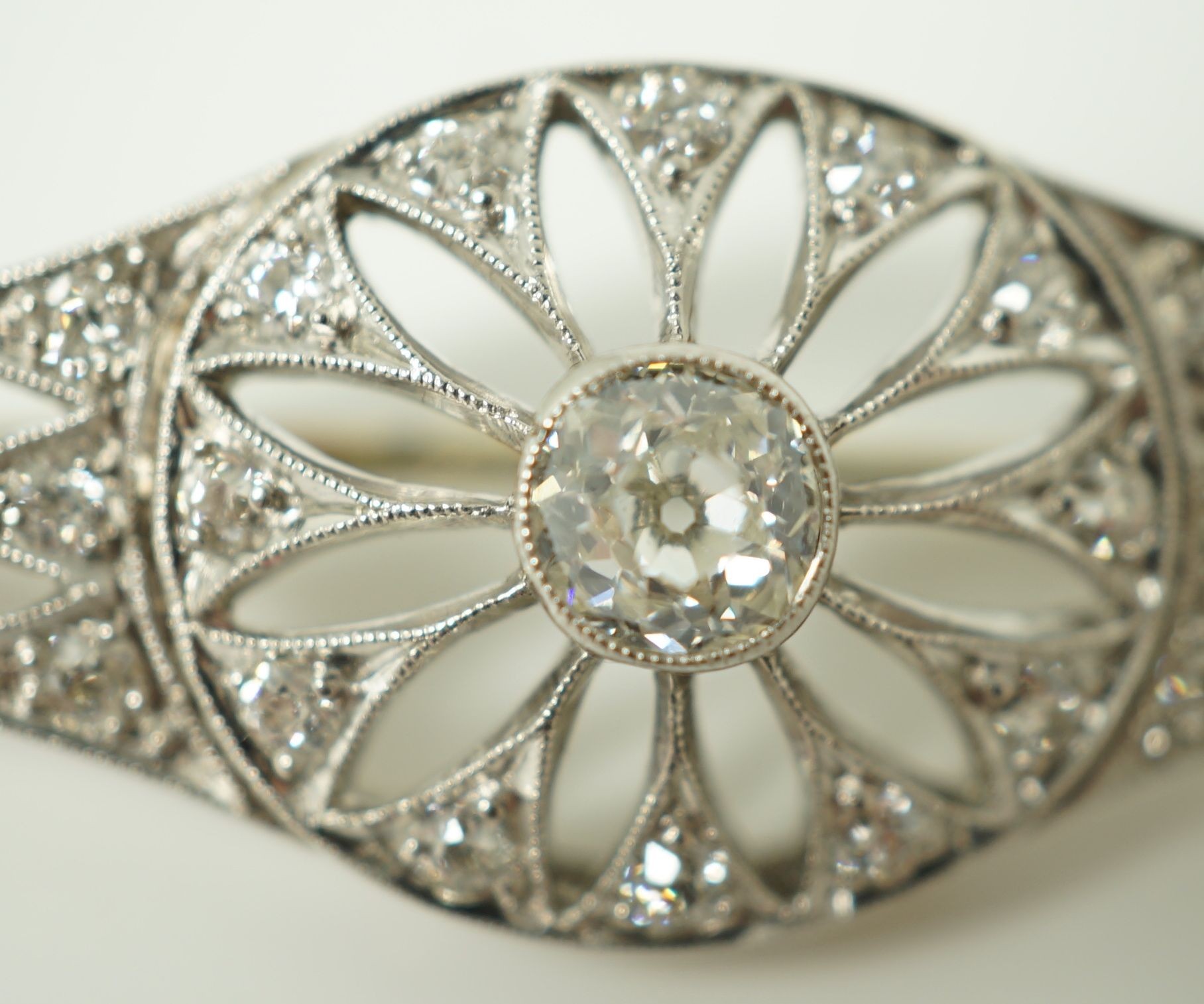 A 1920's pierced white gold and diamond cluster set brooch